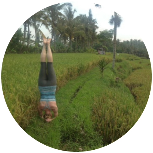 Katherine Sauer doing a headstand in a rice field in Bali