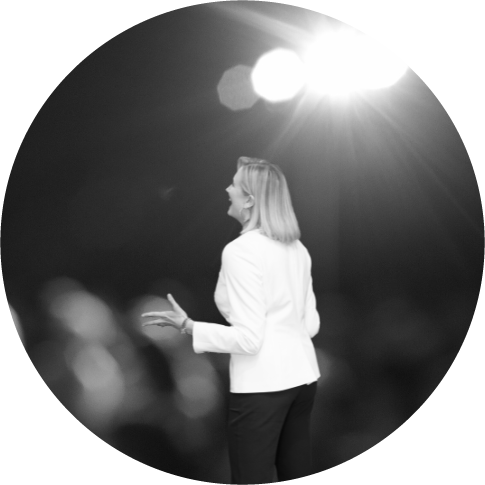 a woman speaking from a stage