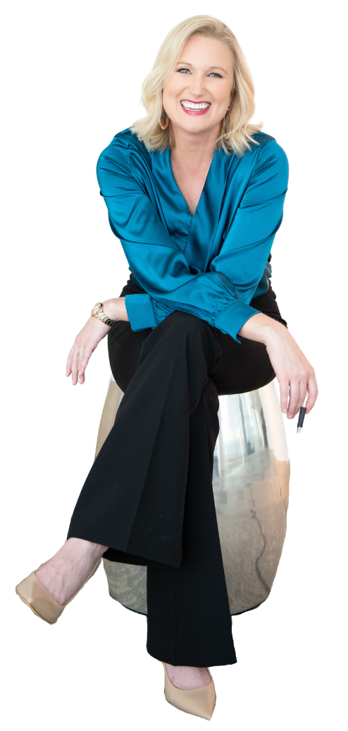Katherine Sauer, a smiling blond woman wears a teal blouse and holds a pen